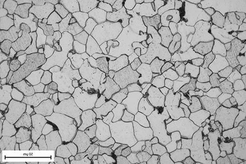 营 reflected light photomicrograph showing the grain structure of a steel pipe.